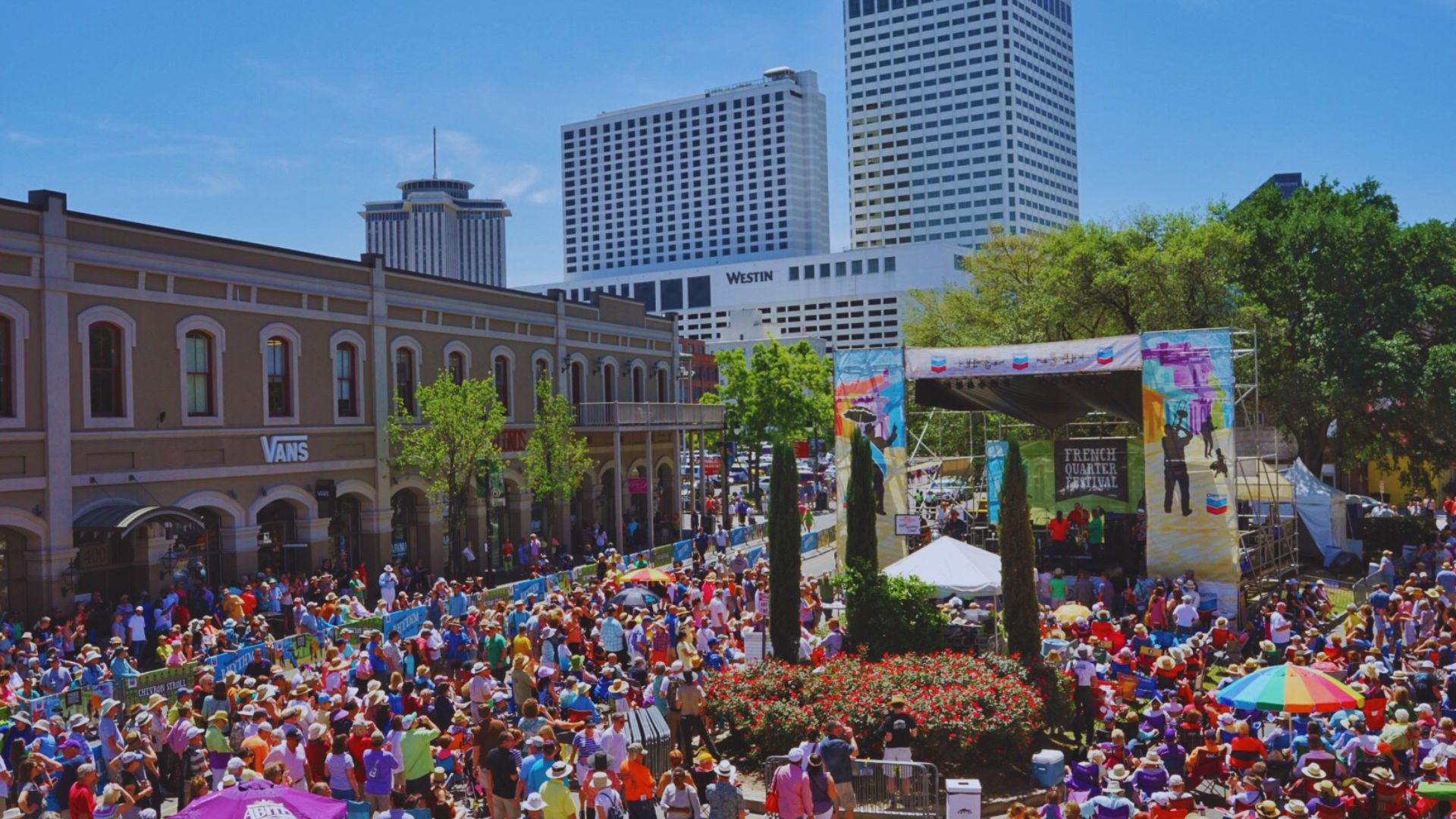 A large crowd of people gathered in a bustling city, showcasing a vibrant urban atmosphere.