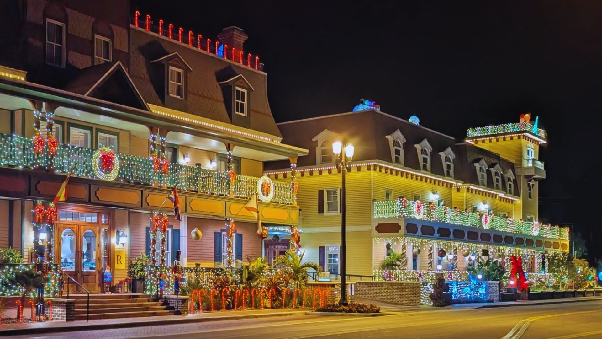Christmas lights adorn the front of a building, creating a festive and colorful holiday atmosphere.