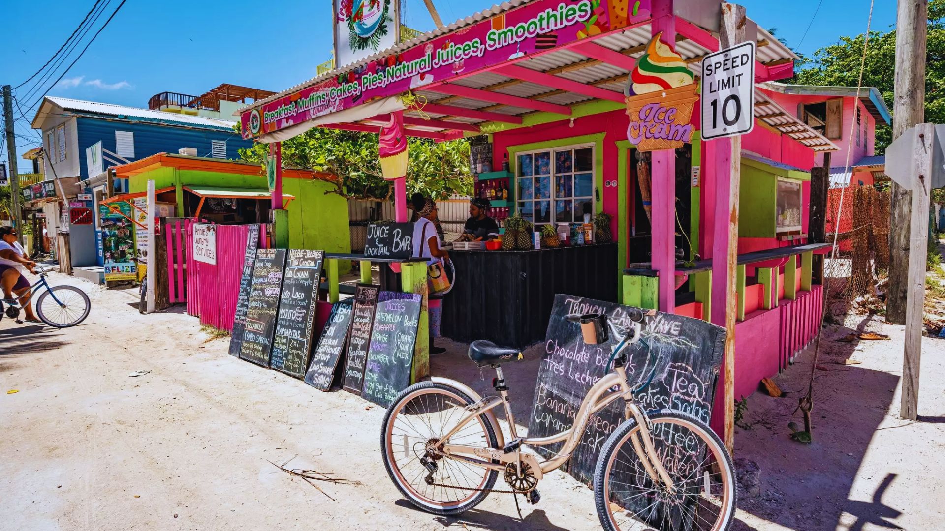 A vibrant building with a variety of bicycles parked in front, showcasing a lively urban scene.