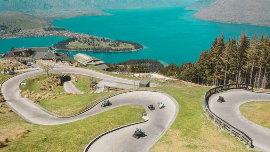 Scenic view of mountain bikers navigating trails in Queenstown, showcasing the region's stunning landscapes and terrain.