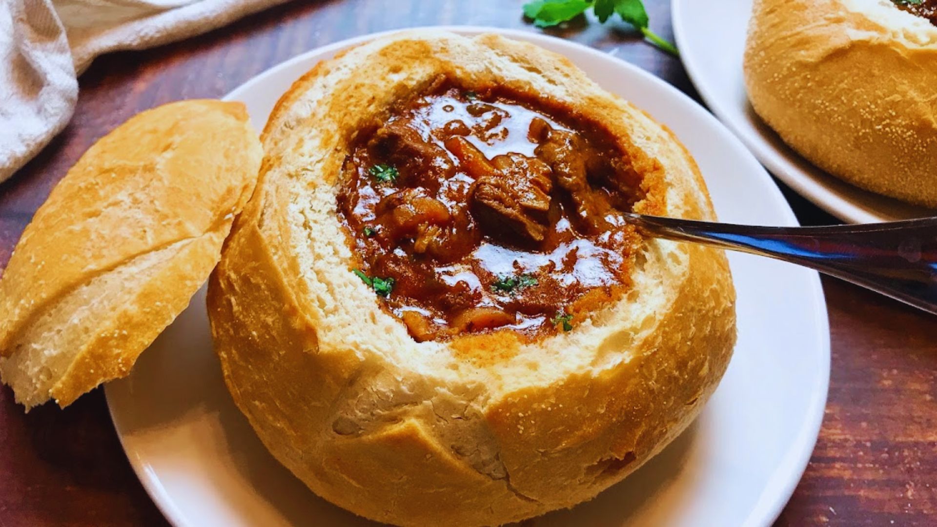 A hearty slow cooker beef stew with tender meat, vegetables, and rich broth, served in a rustic bowl.