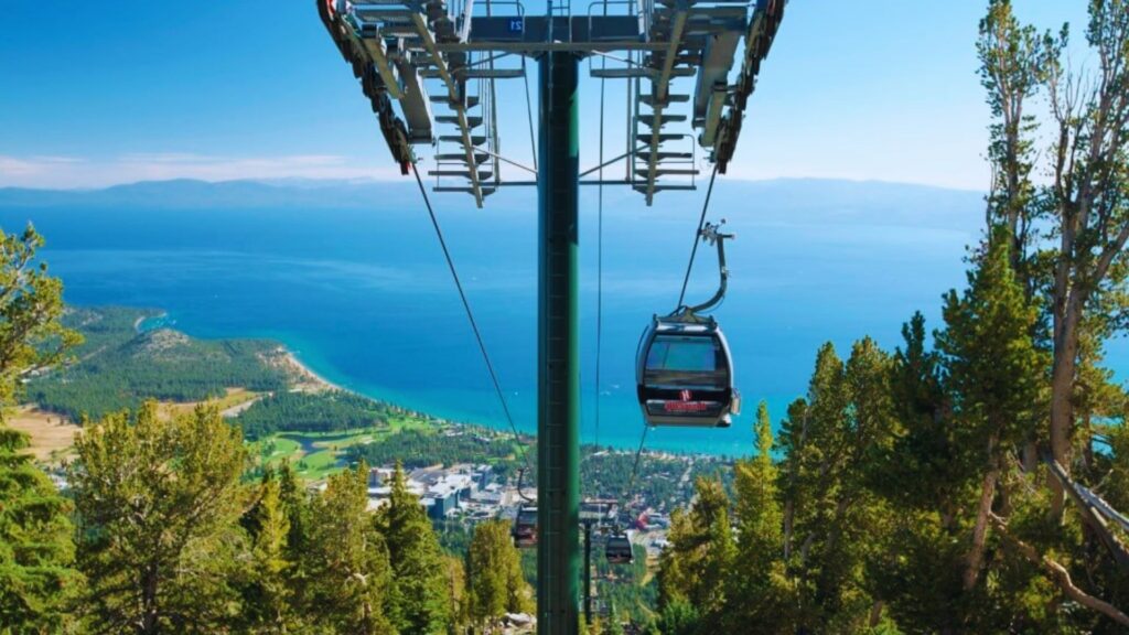 A scenic gondola ride over Lake Tahoe, showcasing the stunning blue water and surrounding mountains.
