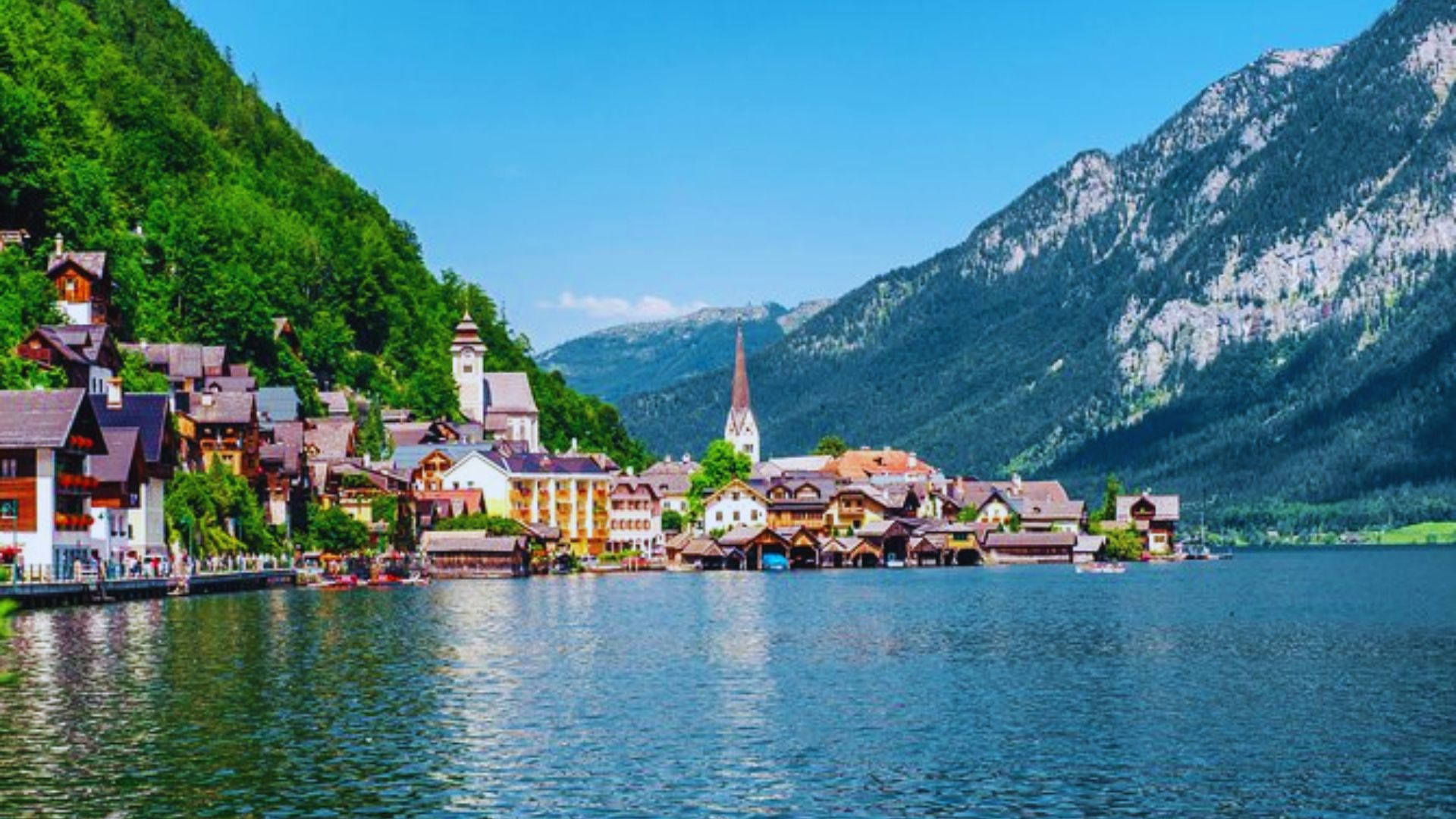 Scenic view of Hallstatt, Austria, showcasing its picturesque lakeside village and surrounding mountains.