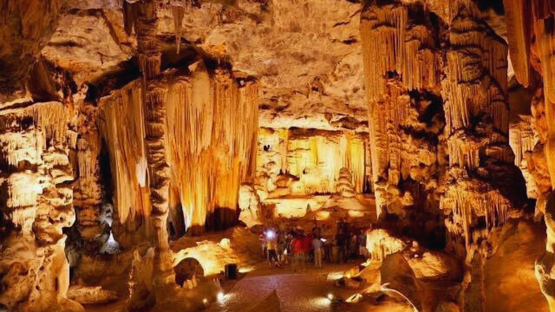 A view of the Cave of the Giants in the Philippines, showcasing its towering rock formations and lush surroundings.