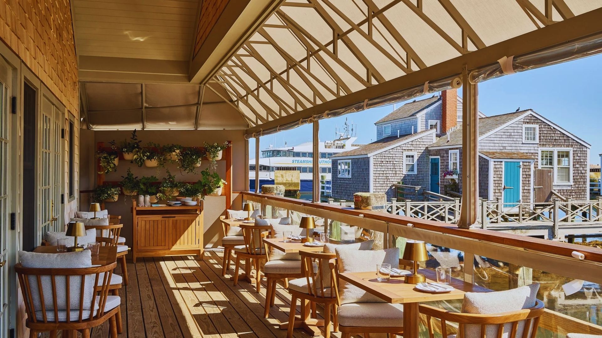 Overlooking the water from a restaurant deck, the image captures a serene dining atmosphere.