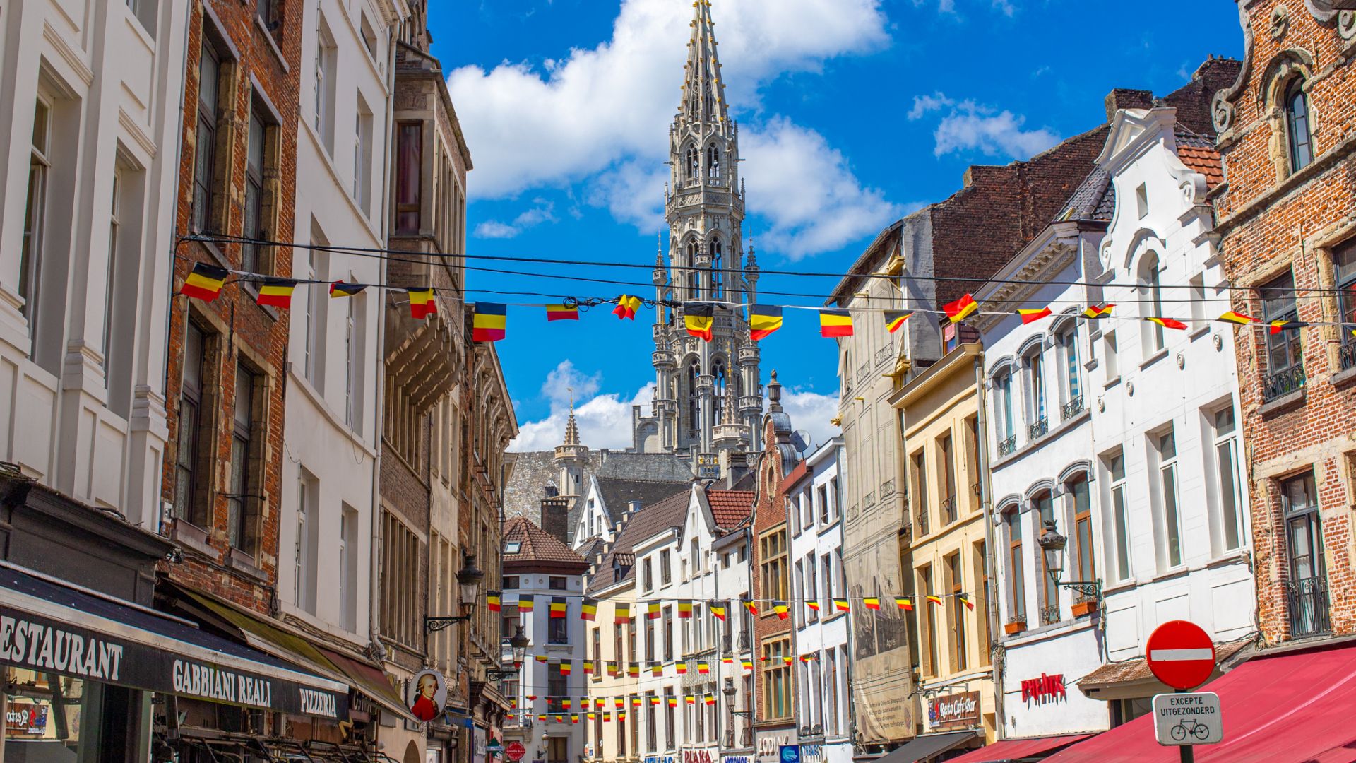 A busy street filled with diverse people walking in various directions, showcasing urban life and activity.
