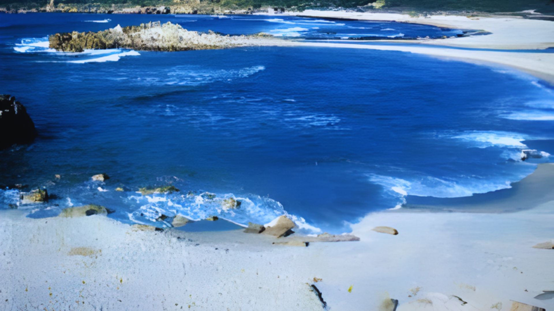 A serene coastal scene with vibrant blue ocean waves gently lapping onto a sandy beach. Rocky outcrops dot the shoreline, under a bright sky.