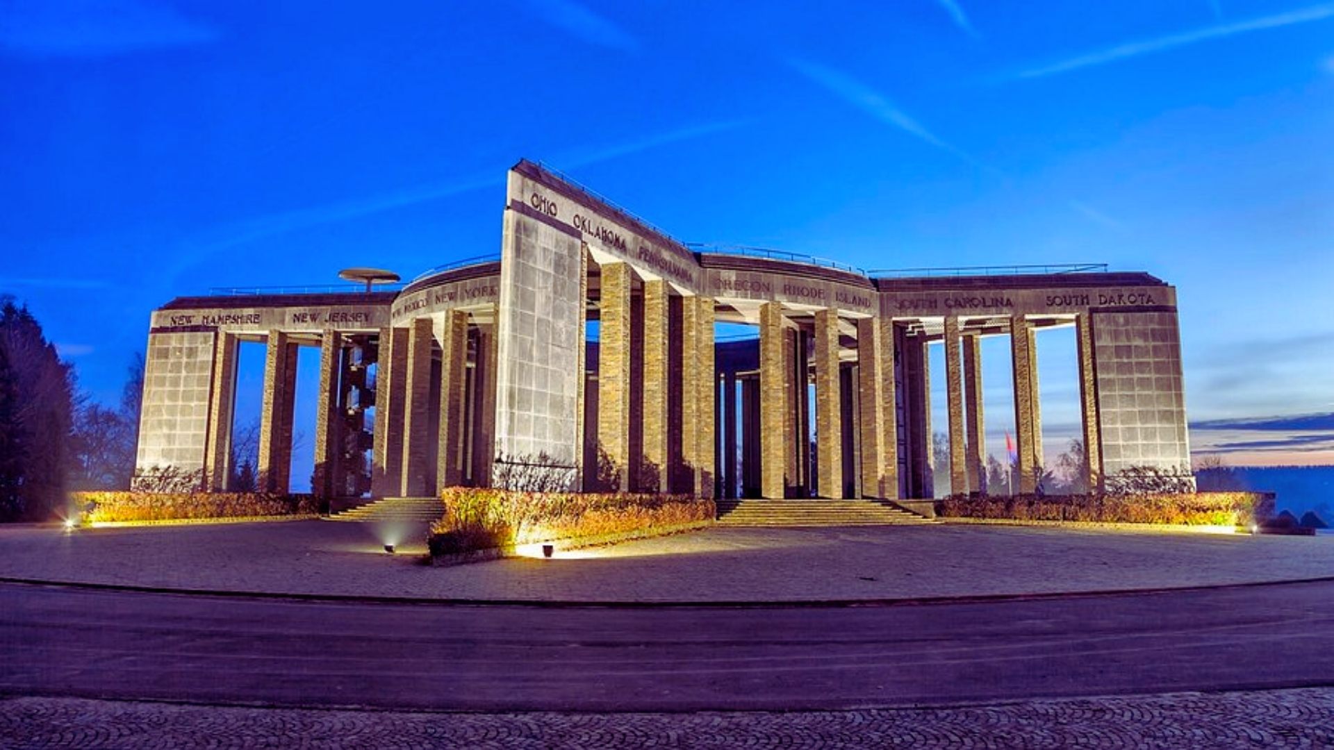 The monument illuminated at night, showcasing its architectural details against a dark sky.