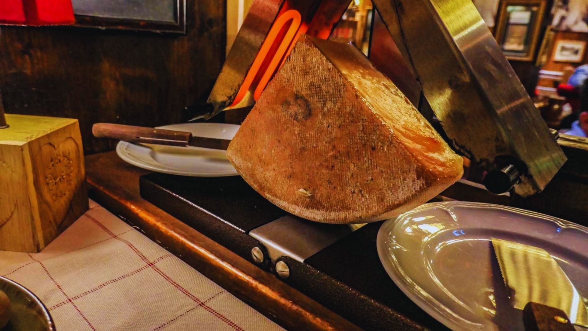 A substantial cut of meat displayed on a plate with a knife beside it, prepared for a meal.
