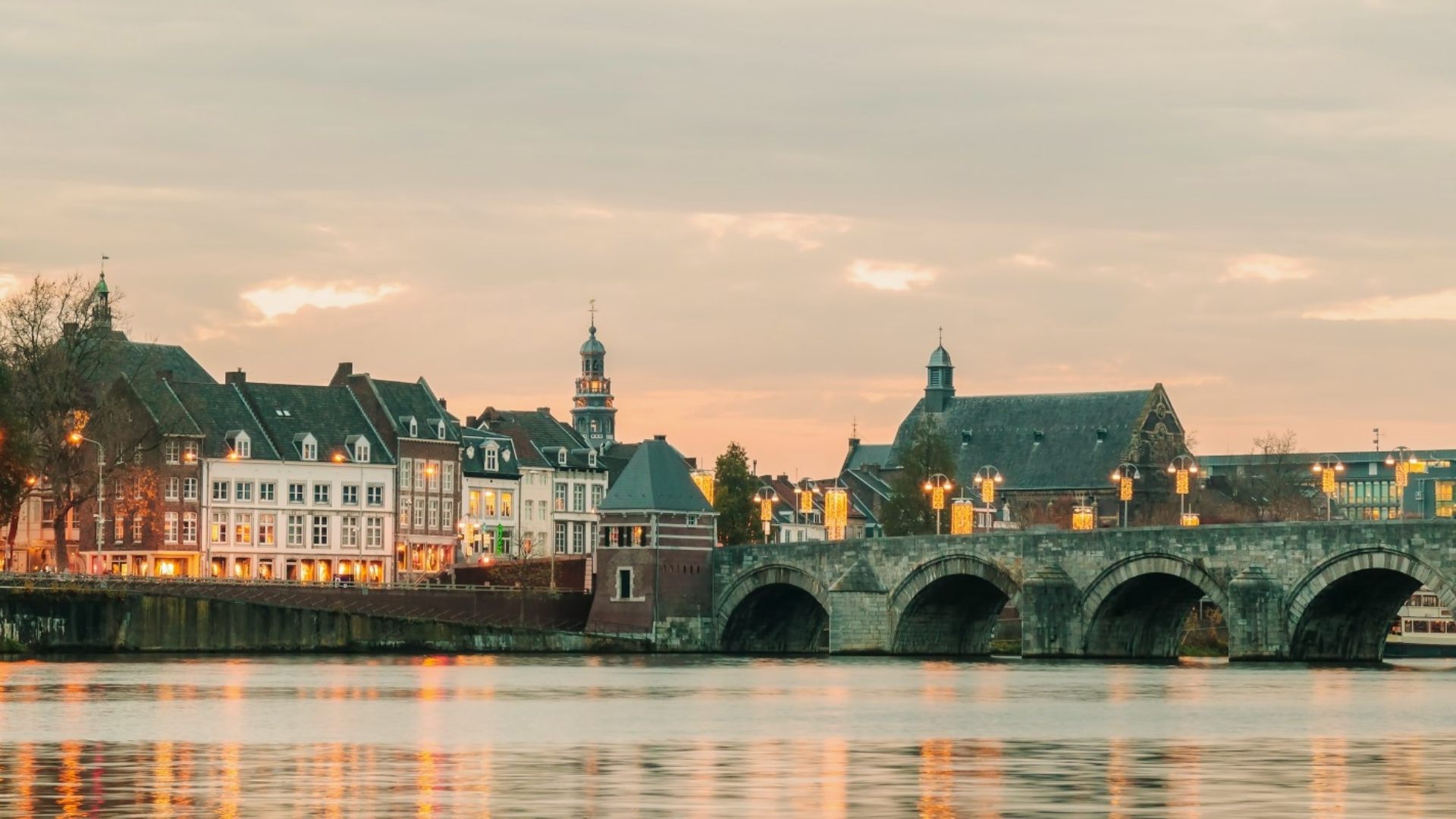Sunset over the city of Bruges, Belgium, highlighting its historic architecture and tranquil canals.