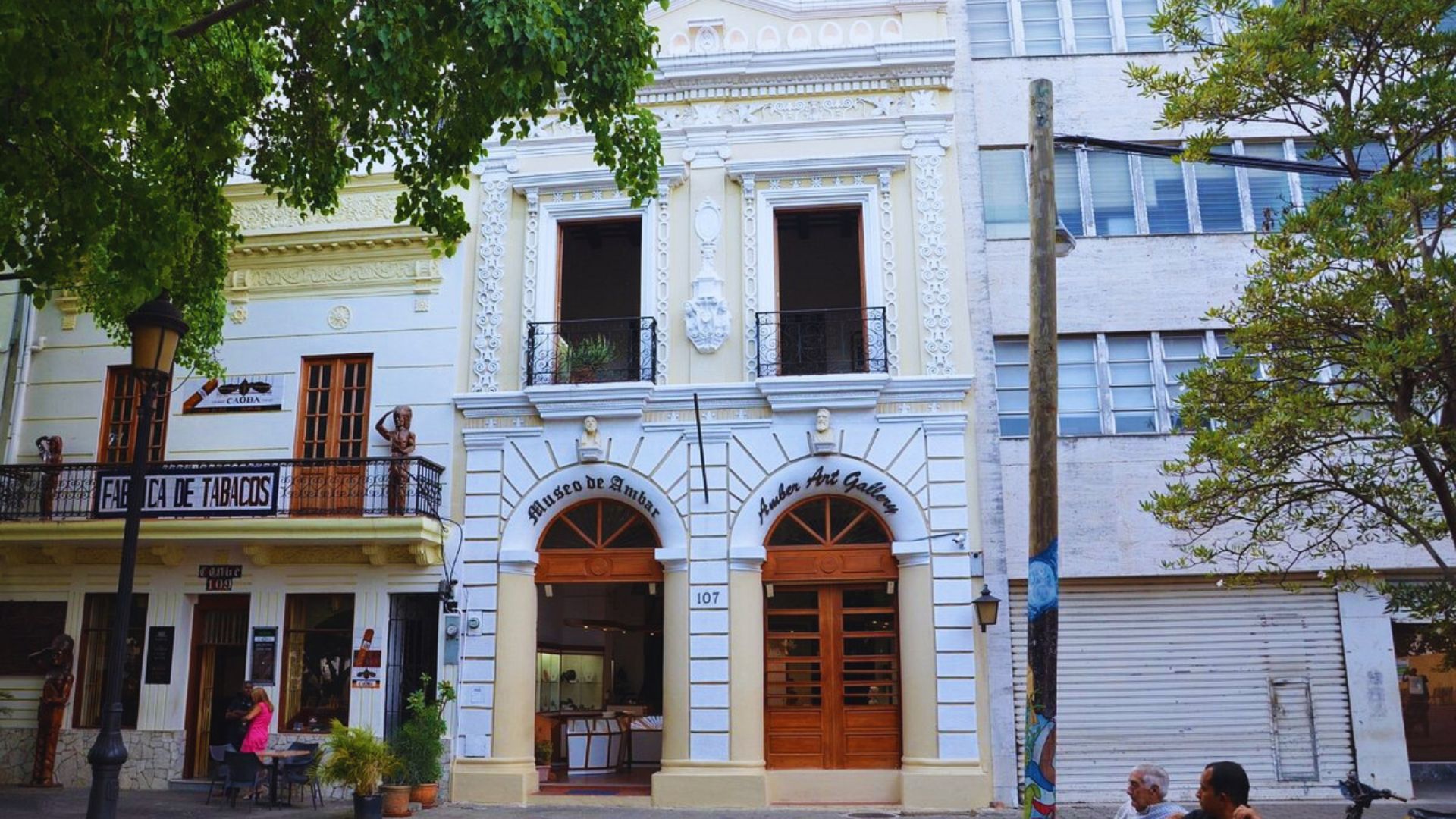 A building featuring a prominent balcony and an additional side balcony, showcasing modern architectural design.
