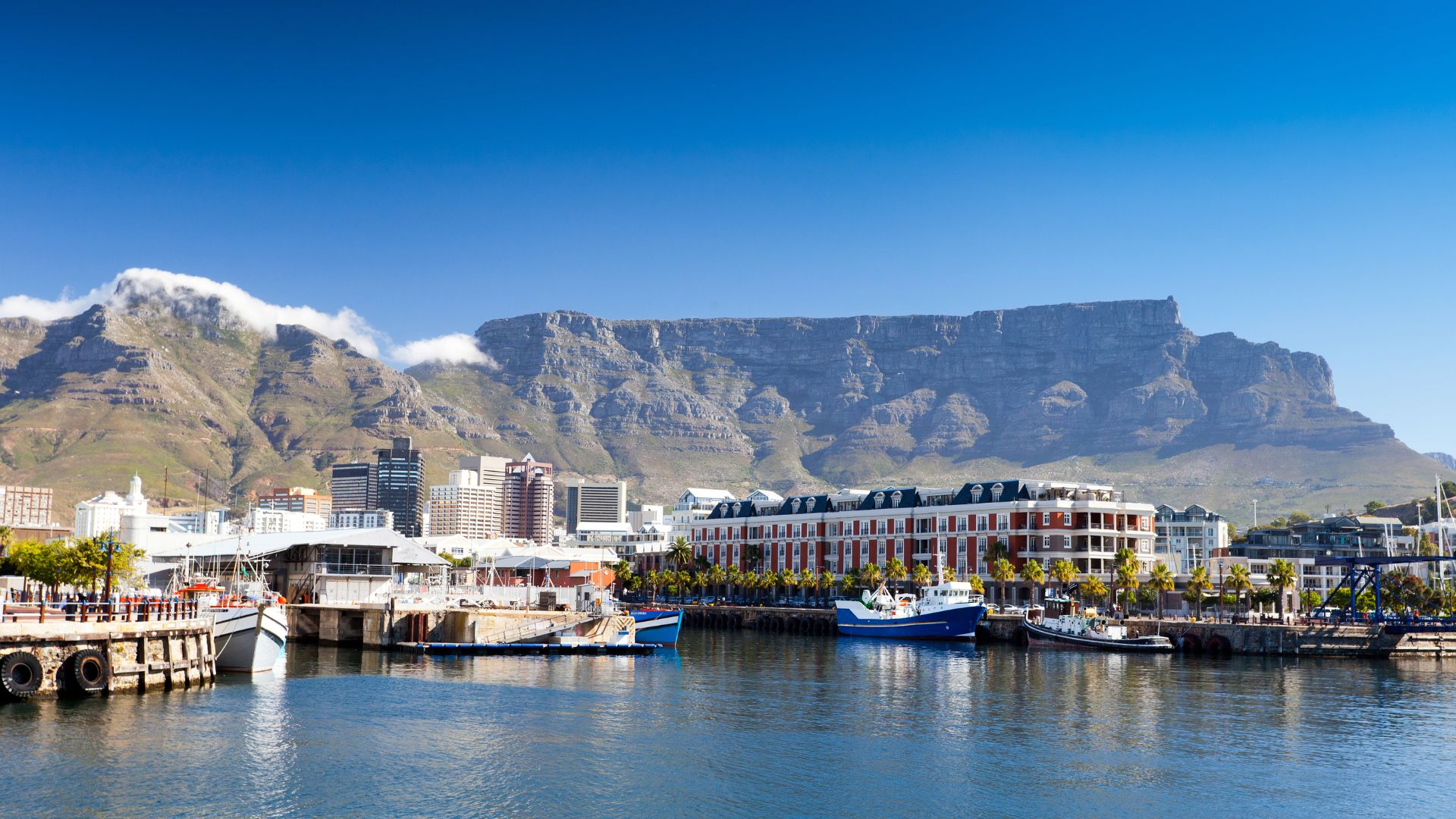 Table Mountain rises majestically over Cape Town, South Africa, showcasing its flat-topped silhouette against the sky.