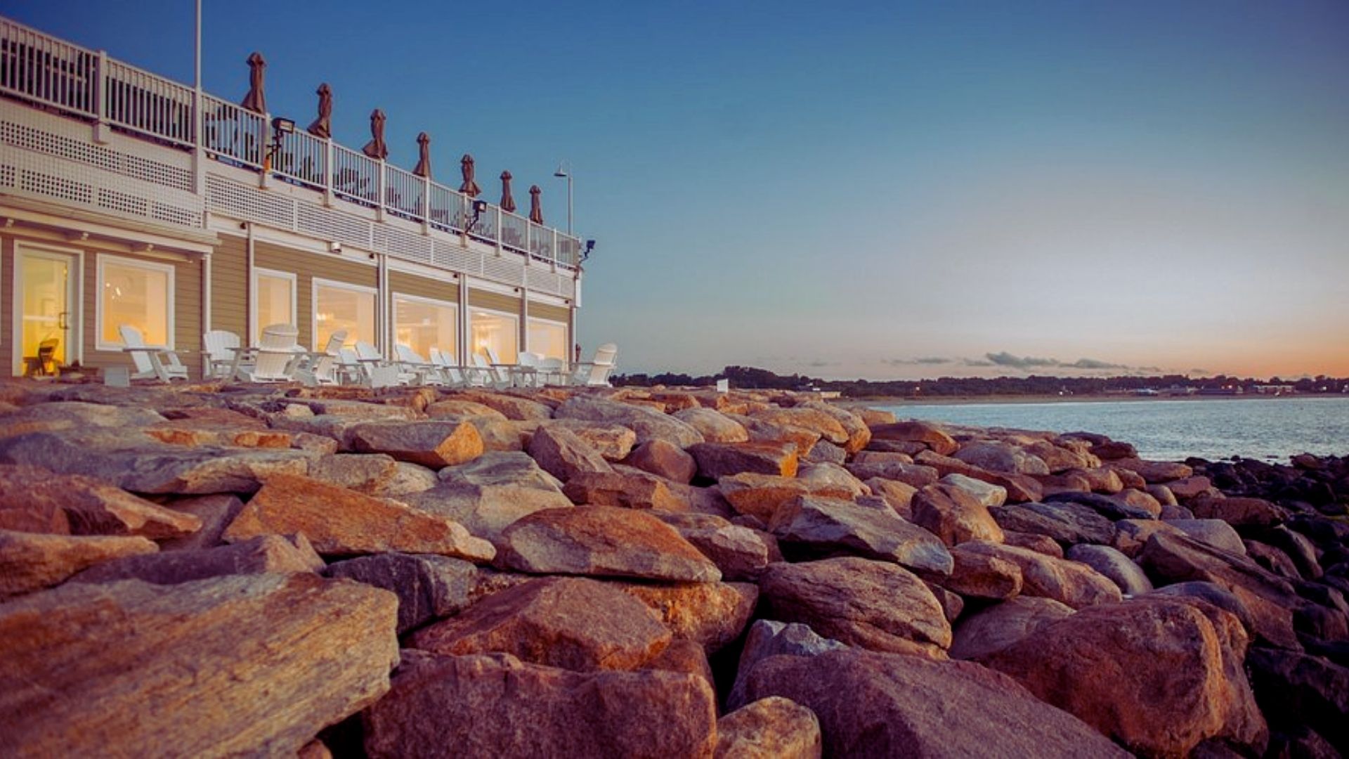 Oceanfront restaurant at the Inn at Cape Cod, featuring outdoor seating with views of the ocean and coastal scenery.