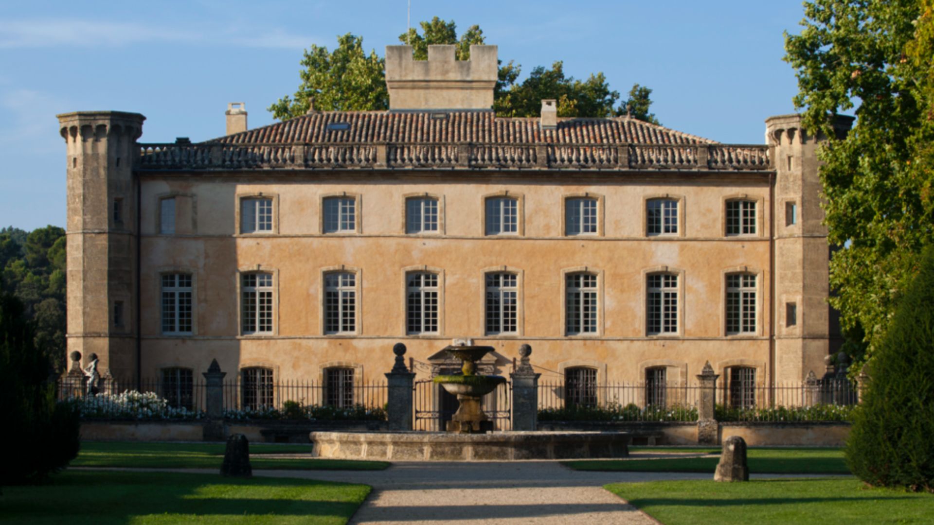 A large building stands prominently with a decorative fountain in front, enhancing the architectural landscape.