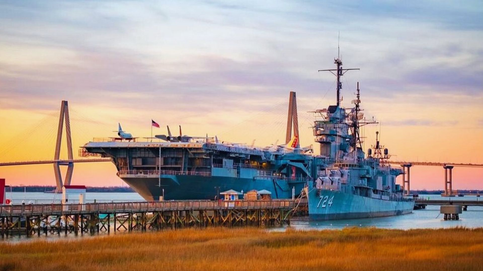 USS Columbia docked in Charleston Harbor, showcasing its naval architecture against a clear blue sky.