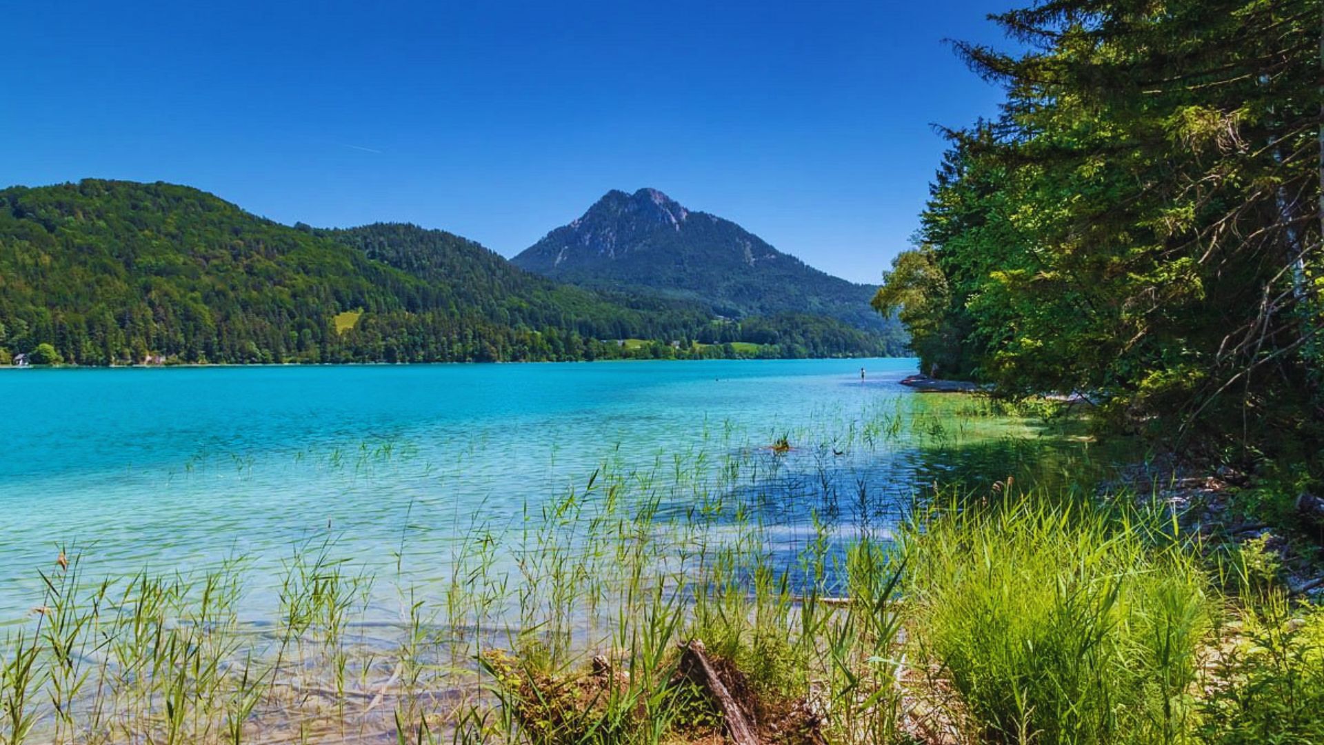 Stunning blue lake nestled among mountains, showcasing a picturesque landscape of natural beauty and tranquility.