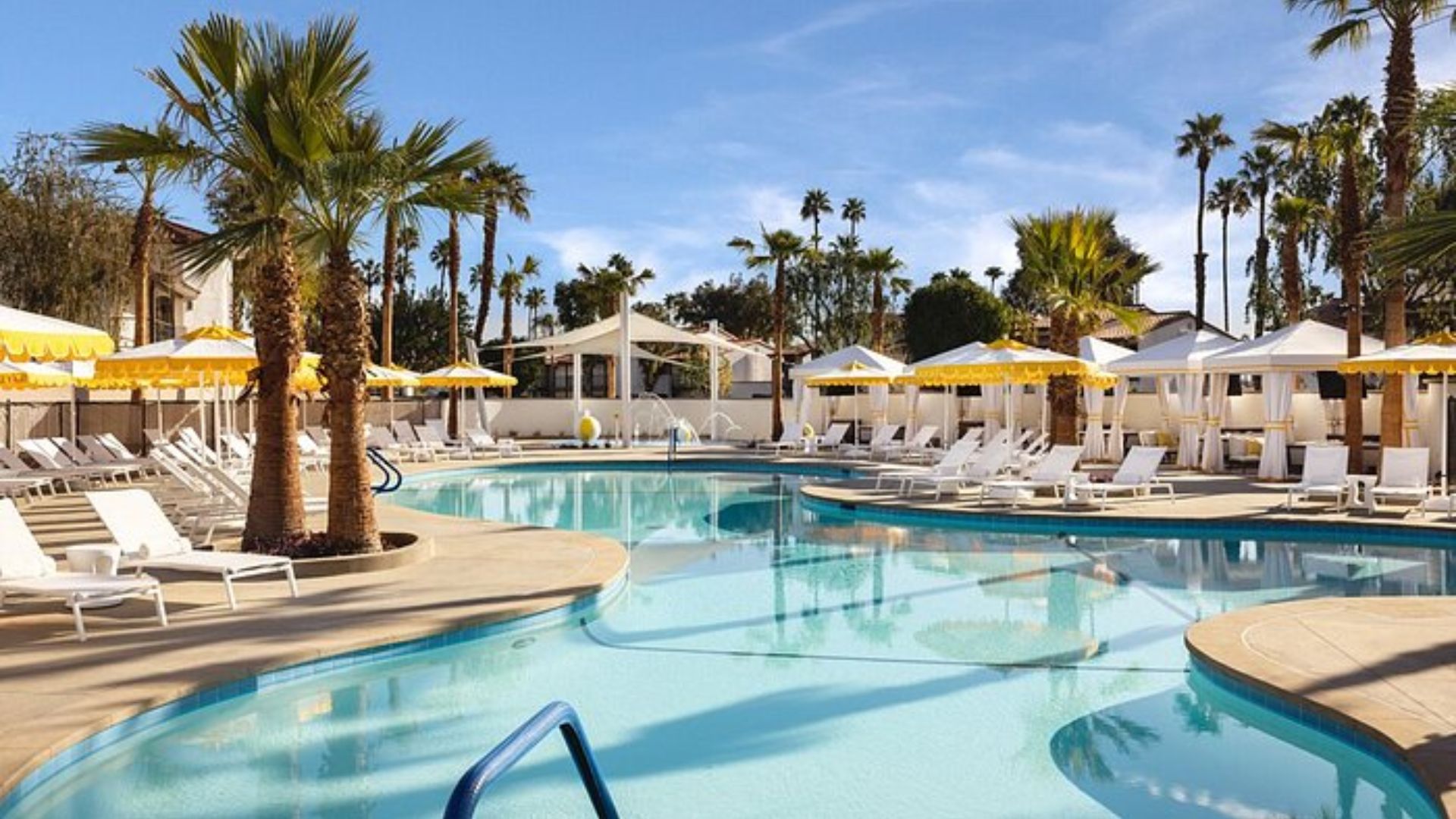 3. A tranquil pool surrounded by lounge chairs and umbrellas, basking in sunlight.