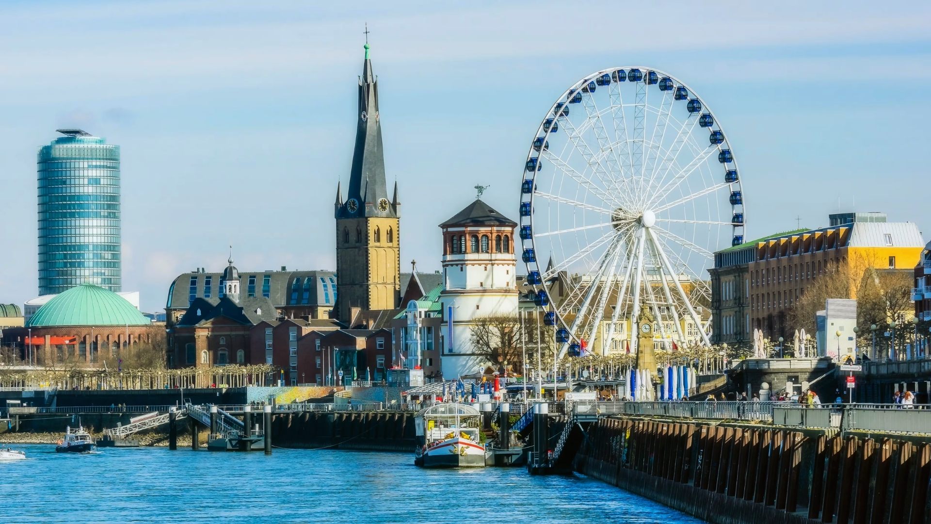 A panoramic view of Hamburg's skyline from the water, showcasing its iconic buildings and vibrant city life.