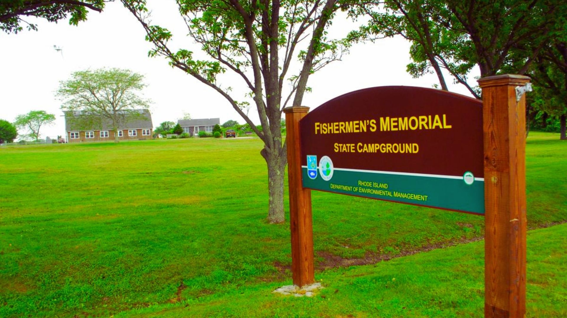 Sign indicating "Firemen's Memorial Park" at the entrance of a park dedicated to honoring firefighters.