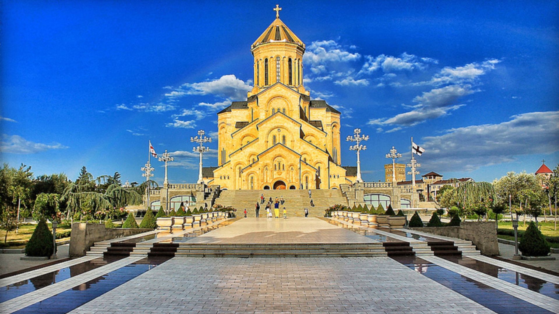 A large church featuring a prominent steeple rising above its roof.