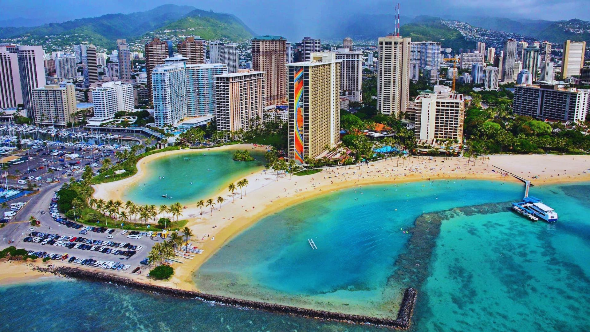 Aerial view of Honolulu, Hawaii, showcasing the cityscape, beaches, and surrounding mountains.