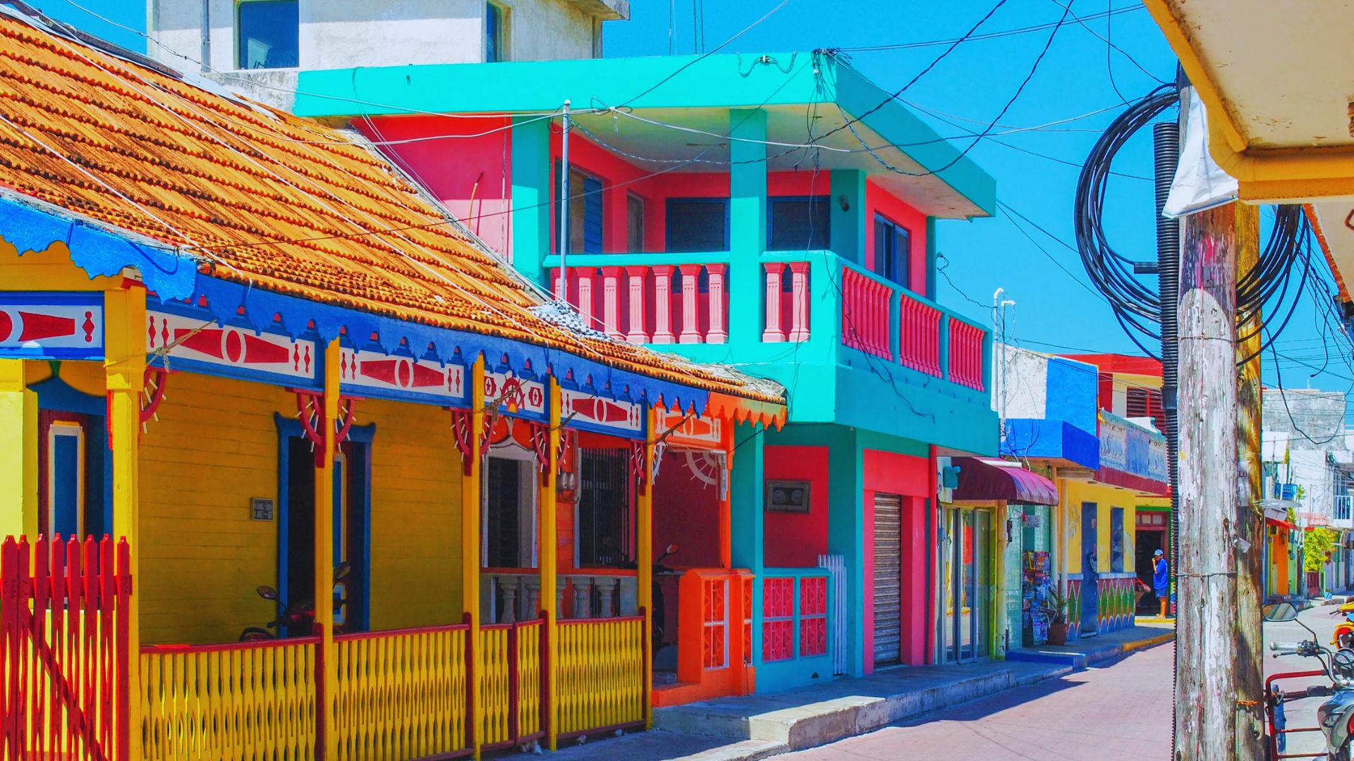 Colorful houses in various hues line the streets of a charming small town, creating a vibrant and inviting atmosphere.