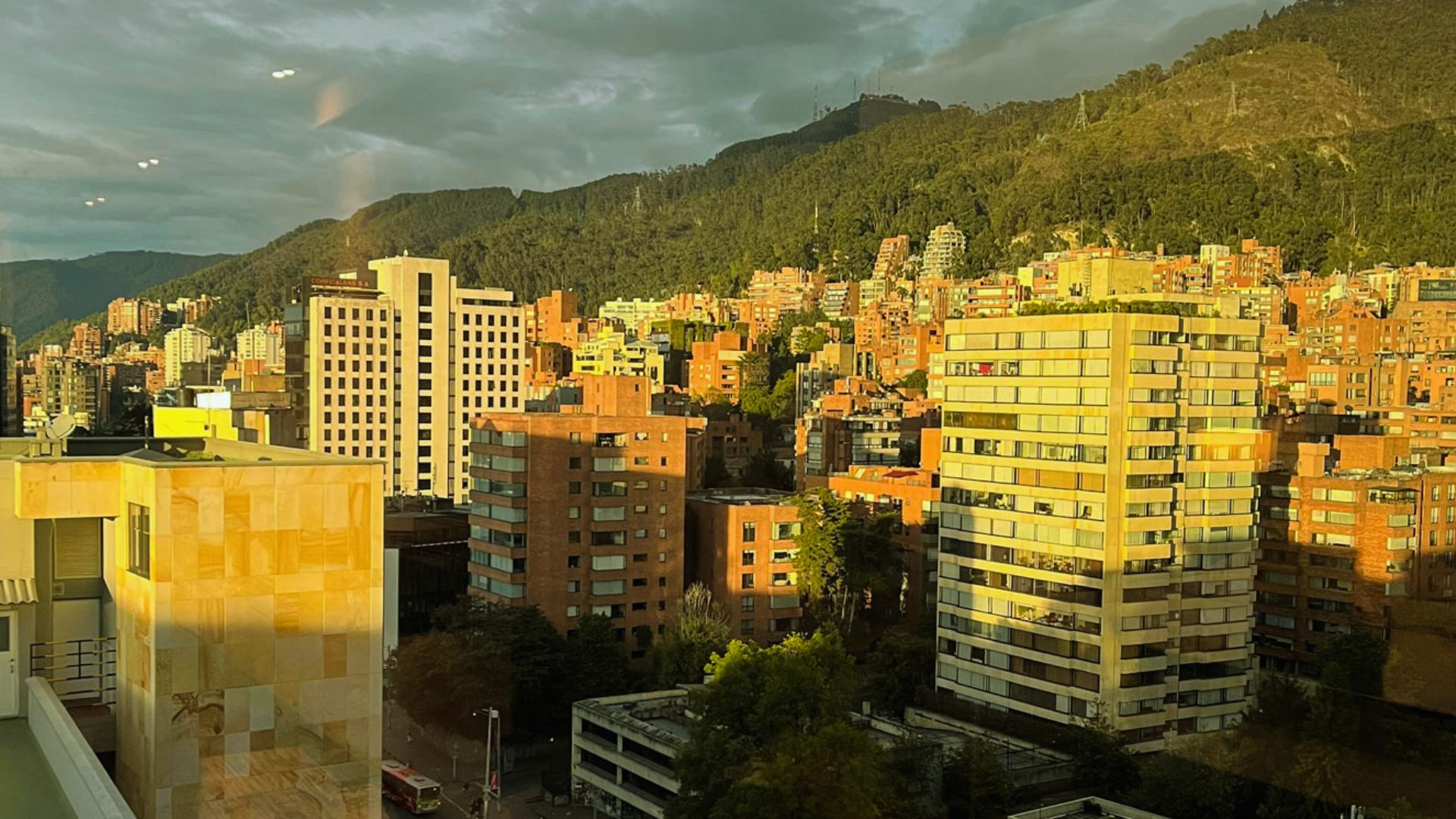 A panoramic view of the city skyline seen through a large window in a modern building.