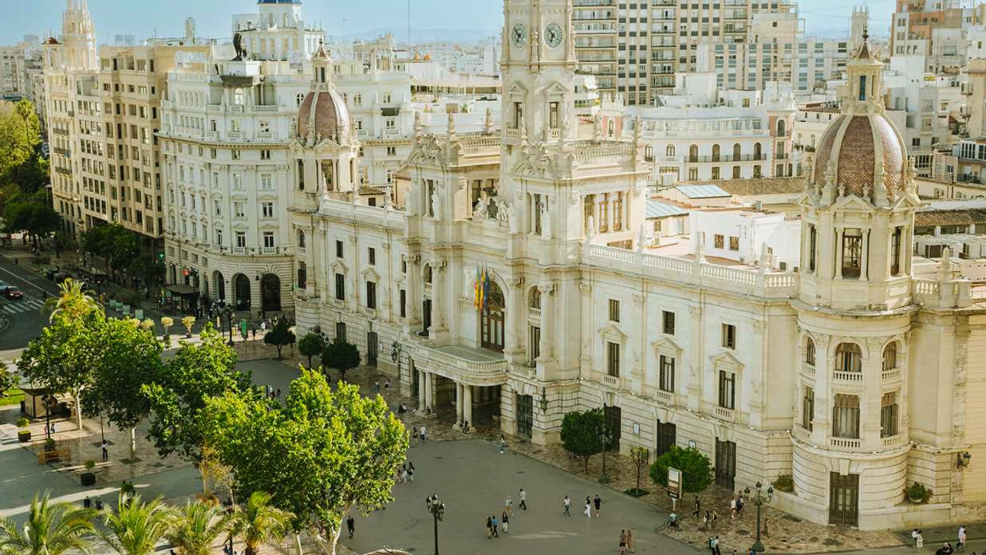 A sprawling cityscape featuring numerous buildings and lush trees throughout the urban environment.