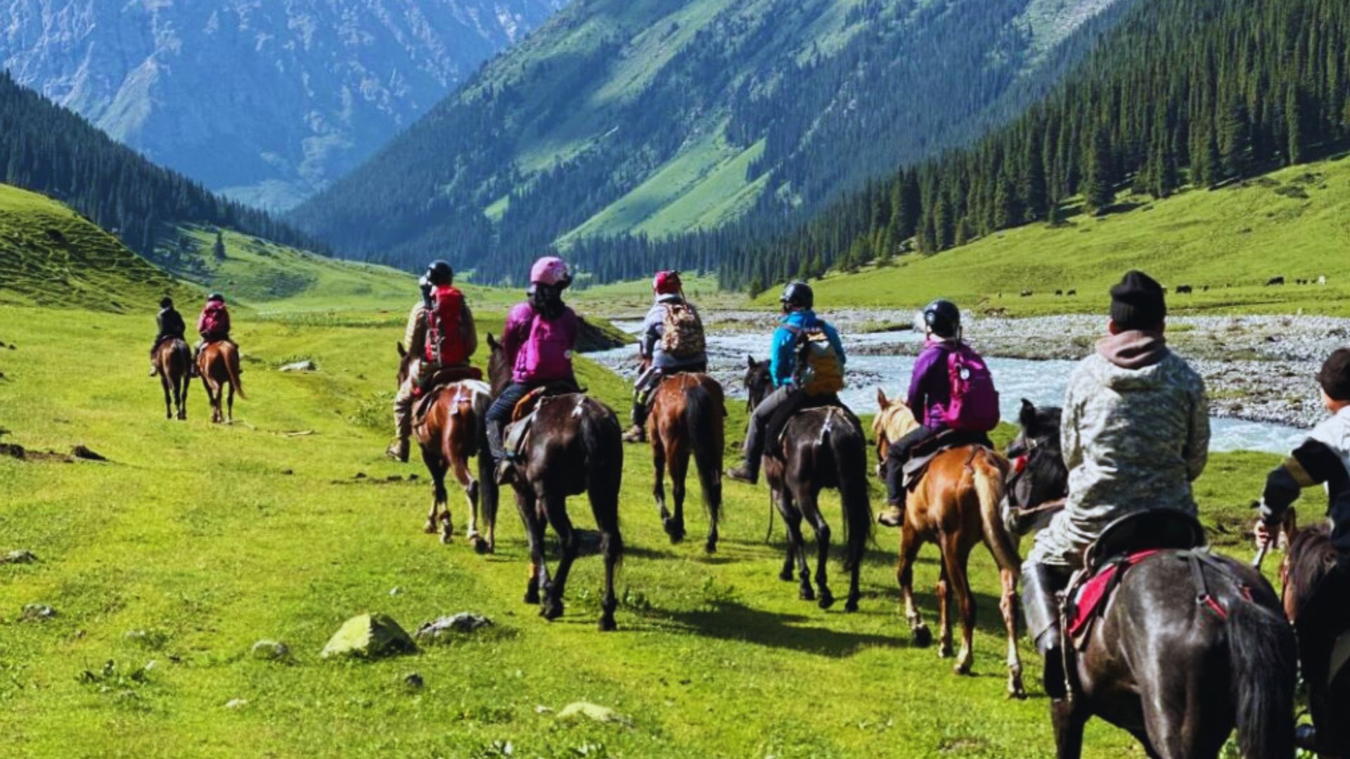 A scenic view of horseback riding in Kashmir, showcasing lush landscapes and majestic mountains in the background.