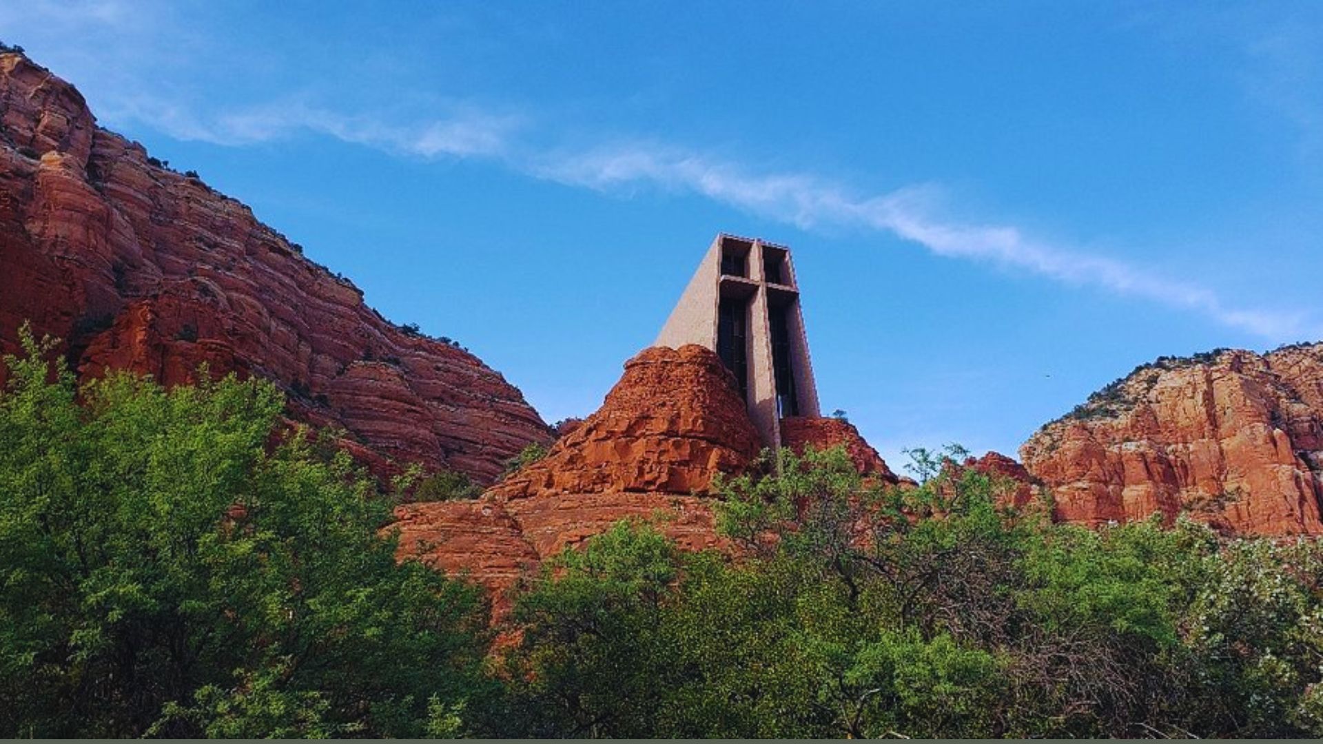 The Church of the Red Rock in Sedona, Arizona, surrounded by stunning red rock formations under a clear blue sky.