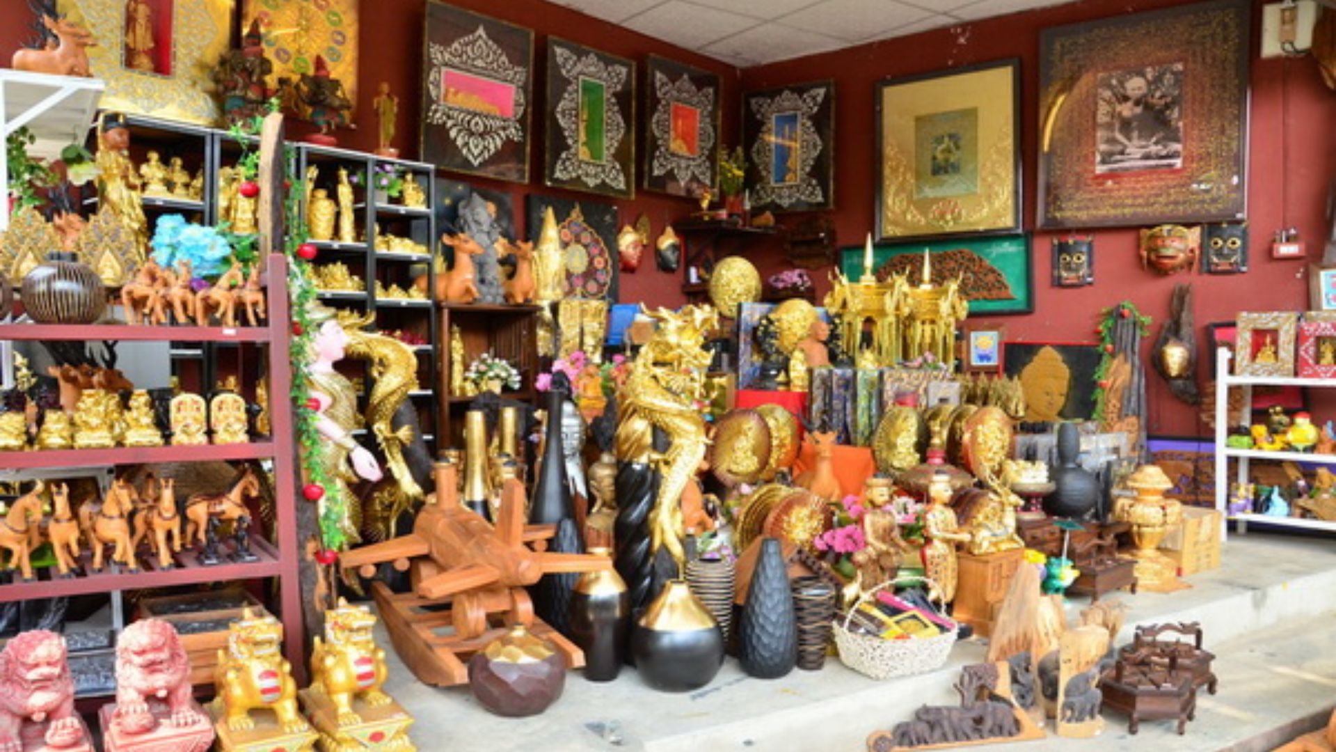 A vibrant shop interior showcasing a variety of art pieces and souvenirs displayed on shelves and tables.