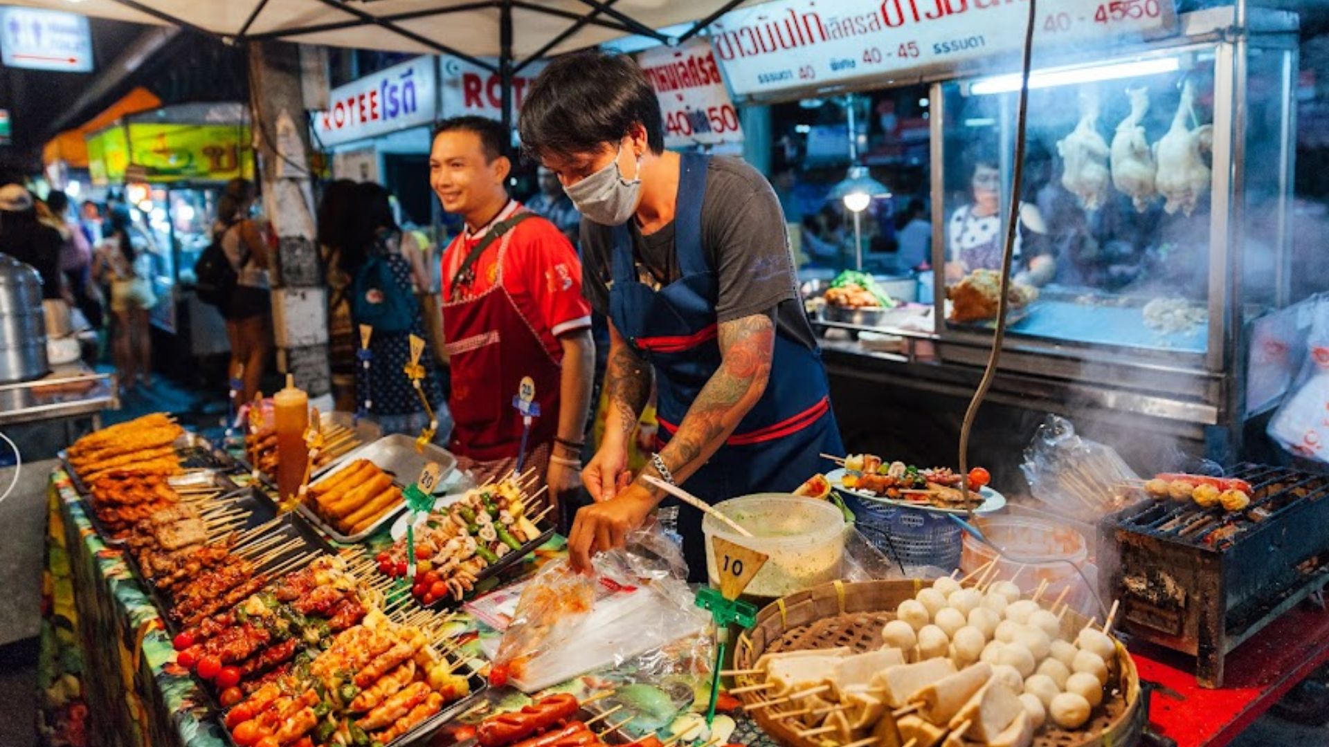 A bustling Thai street food stall in Bangkok, showcasing vibrant dishes and local vendors serving eager customers.