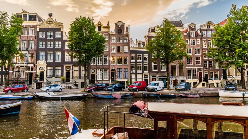 A scenic view of Amsterdam, showcasing its iconic canals and architecture, representing the European Union.