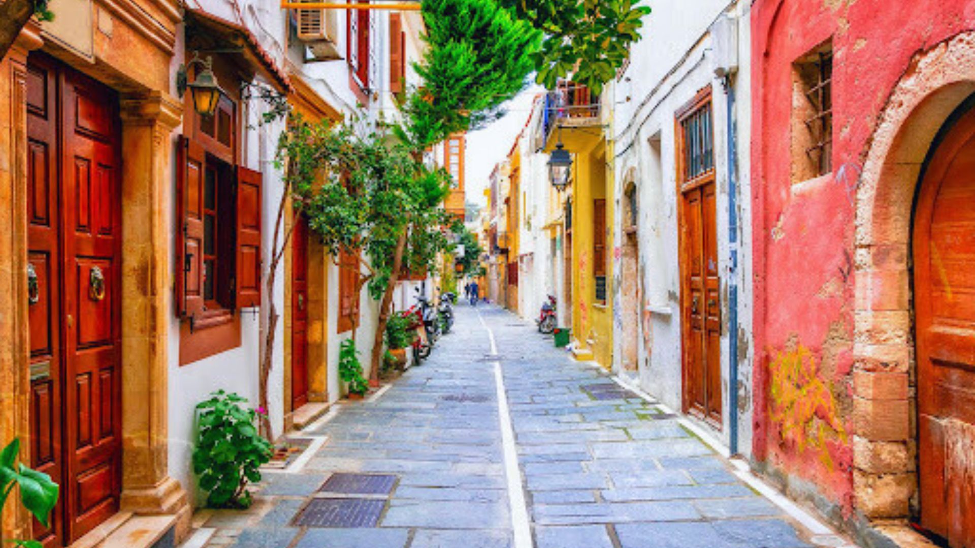 A narrow street lined with vibrant buildings and charming wooden doors, creating a picturesque urban scene.