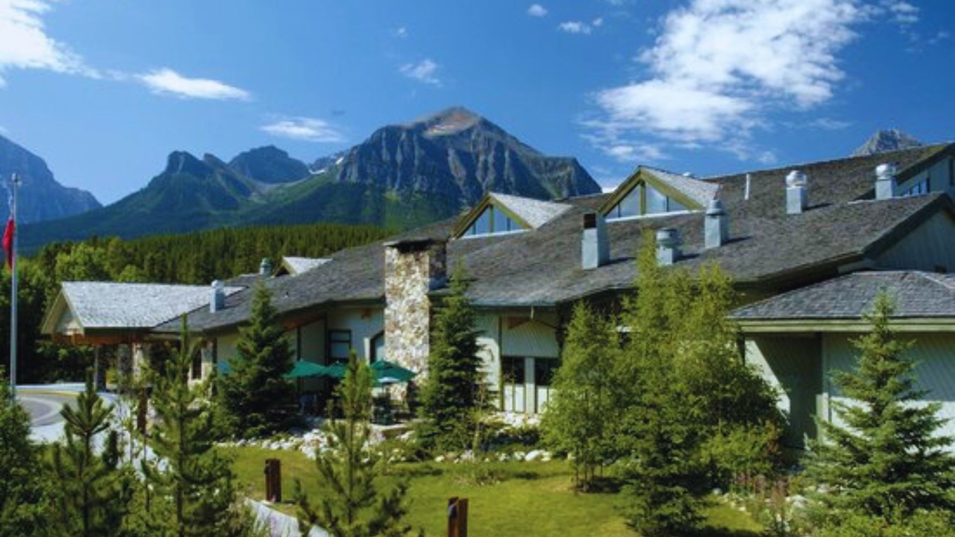 The lodge at Banff National Park, featuring traditional design, set against a backdrop of stunning mountain scenery.