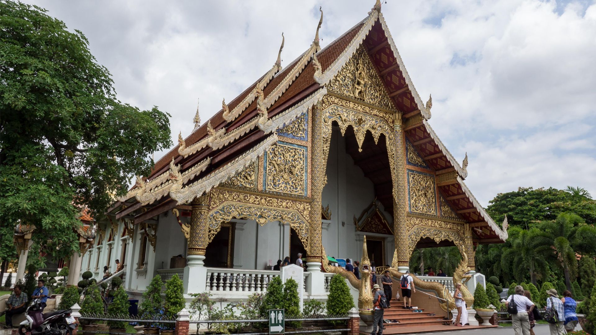 the Grand Palace in Thailand, showcasing intricate architecture and vibrant colors against a clear blue sky.
