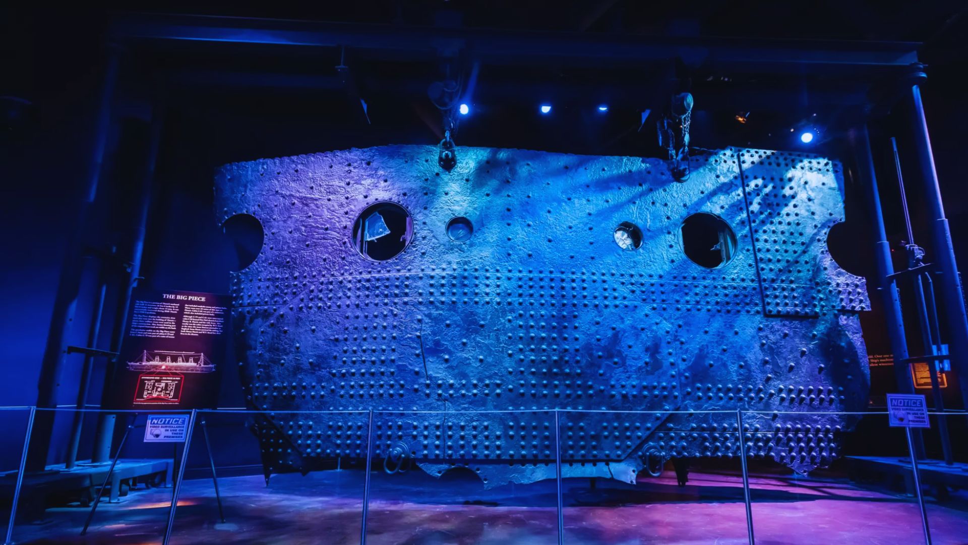 Inside a museum featuring a large, intricate metal structure surrounded by various exhibits and displays.