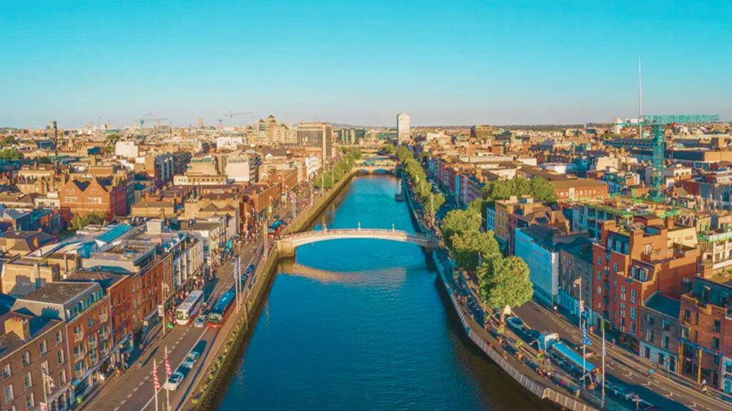 Aerial view of Dublin cityscape featuring the River Liffey winding through the urban landscape.