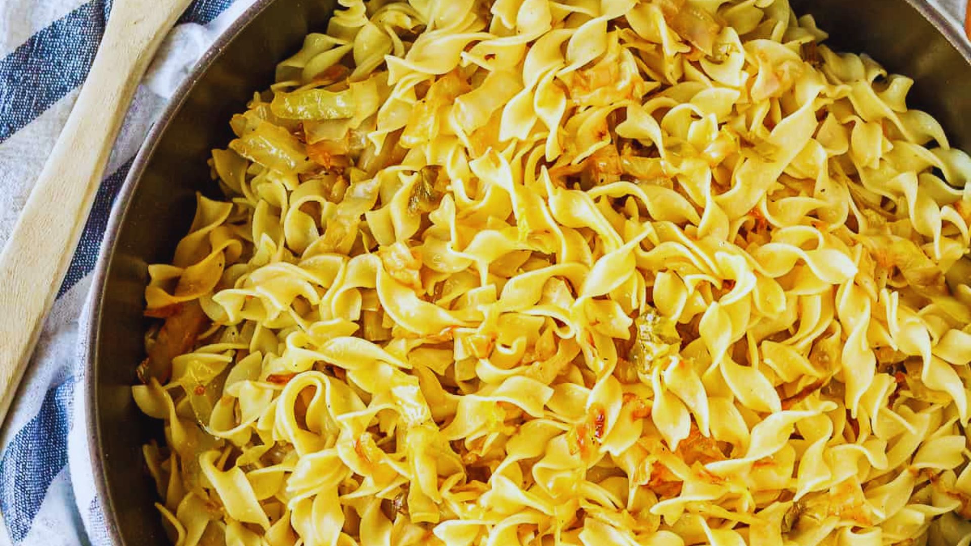 A pan filled with colorful noodles and assorted vegetables, ready to be served.