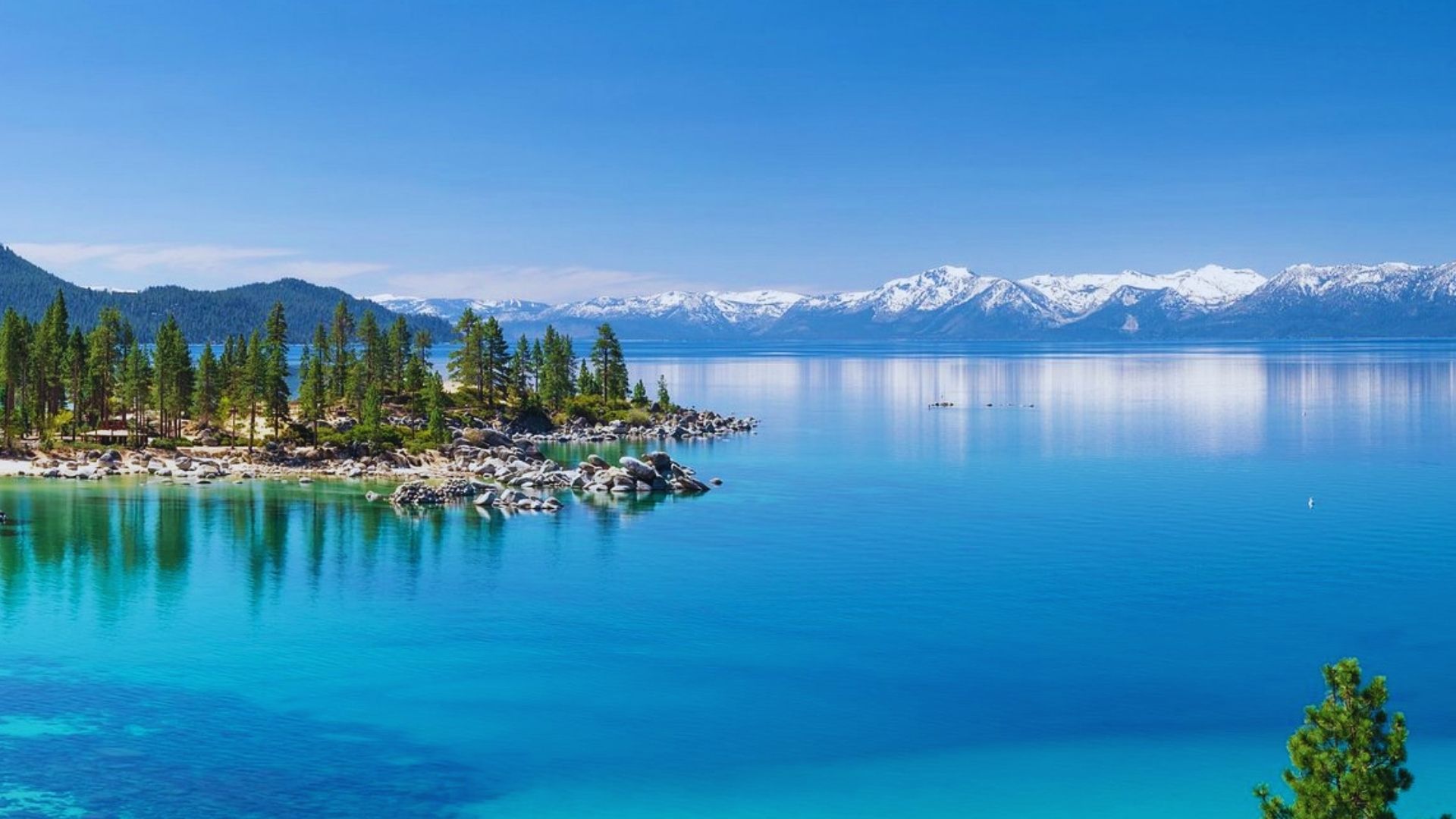 Scenic view of Lake Tahoe, California, showcasing its clear blue waters and surrounding mountains.