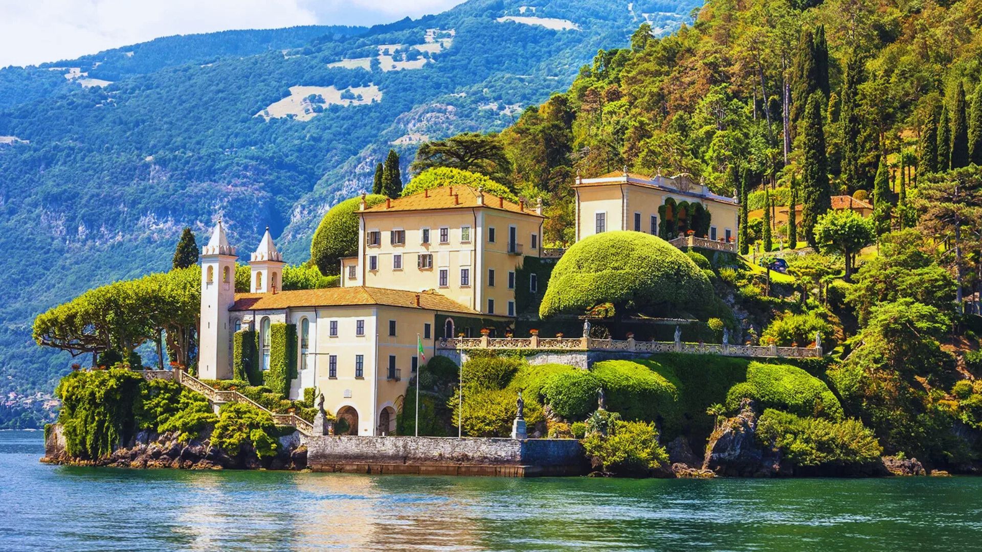 A stunning castle perched on an island surrounded by a serene lake, reflecting the beauty of its surroundings.