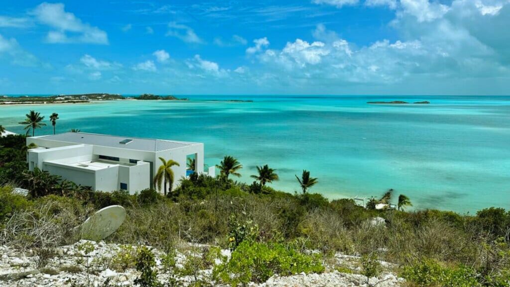 Additional photo of a stunning white sand beach at the White House property in the Bahamas, showcasing clear blue waters.