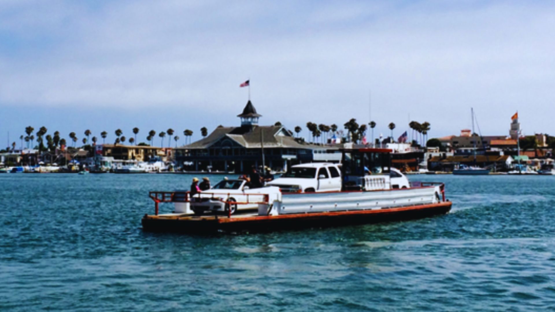 A small boat is anchored in the water beside a pier, with gentle waves lapping at its sides.