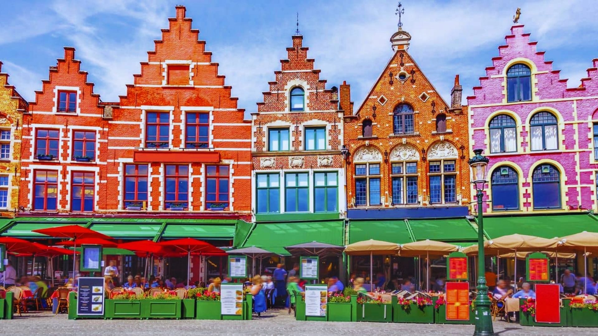 A series of brightly painted buildings in a bustling urban setting, showcasing diverse architectural styles.