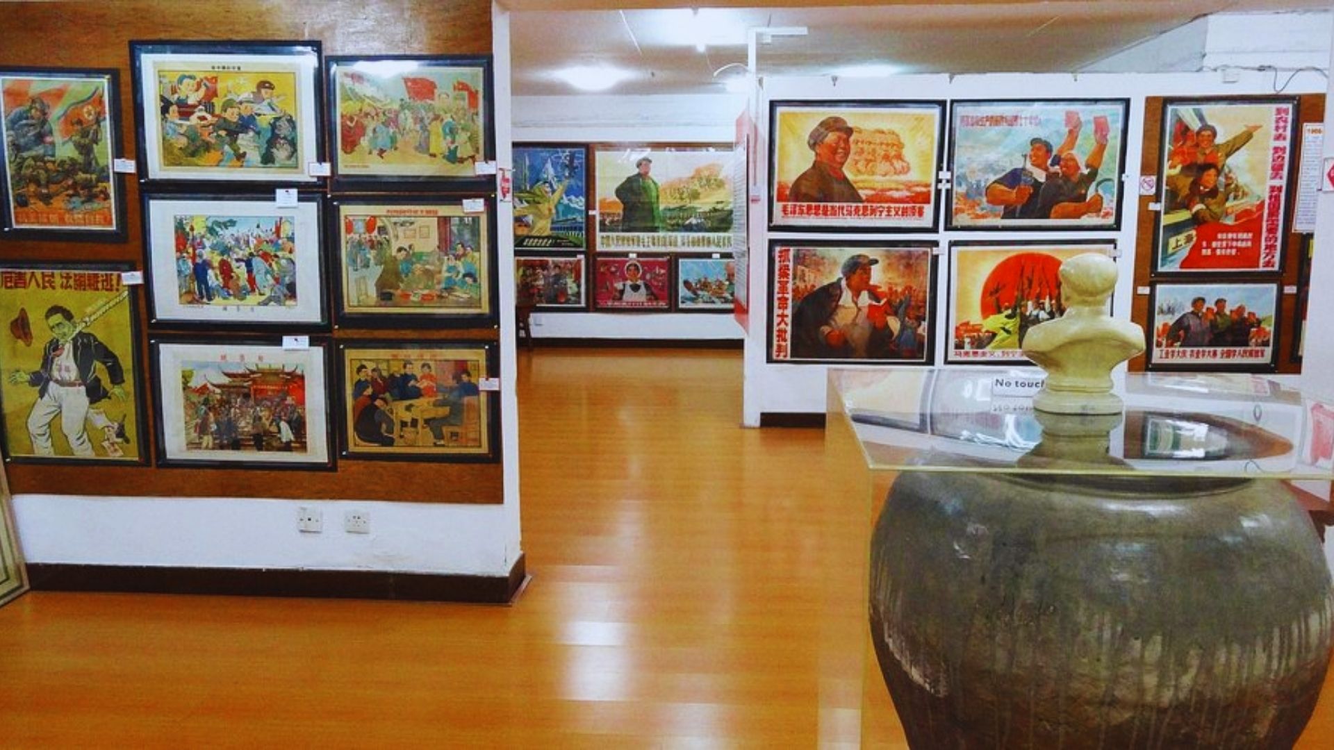 A room filled with various posters and pictures adorning the walls, creating a vibrant and colorful atmosphere.