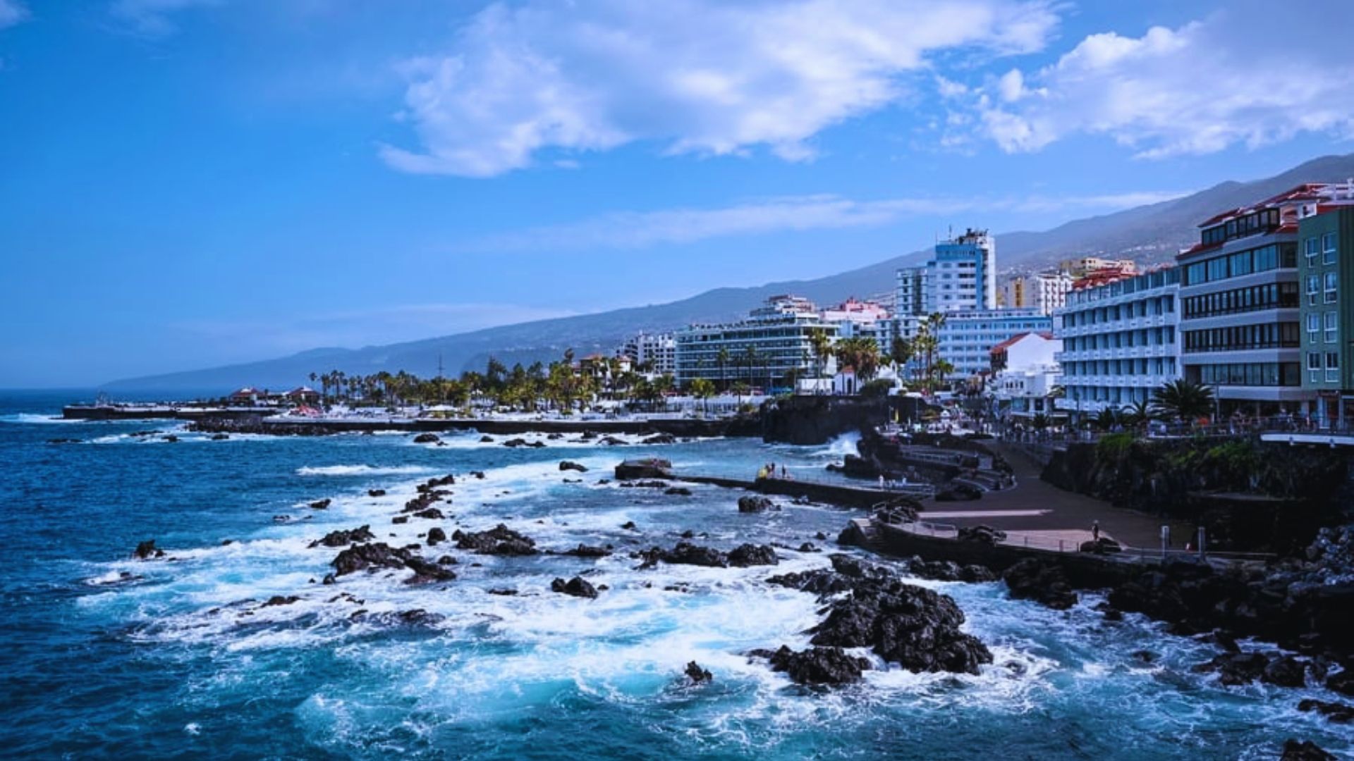 Scenic view of the Canary Islands' coastline in Spain, featuring sandy beaches and clear blue waters.