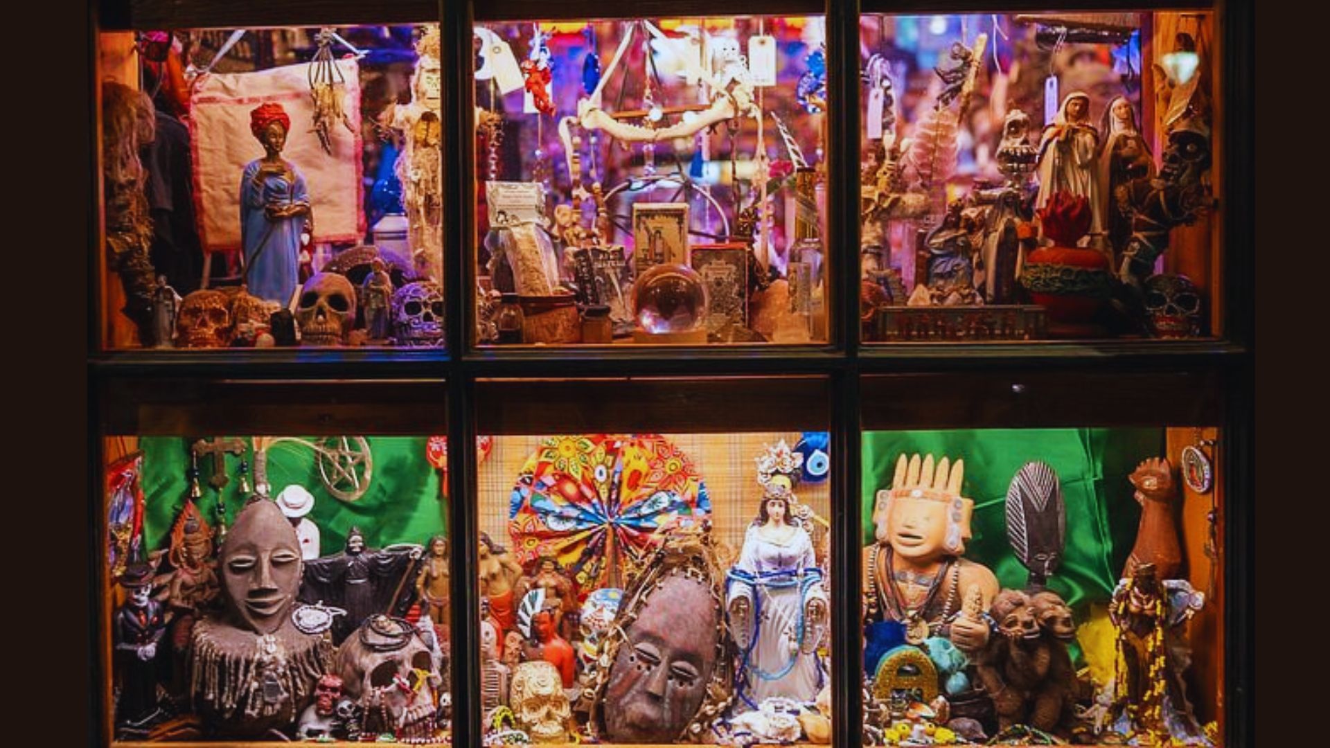 A vibrant window display showcasing a variety of items, including clothing, accessories, and decorative objects.