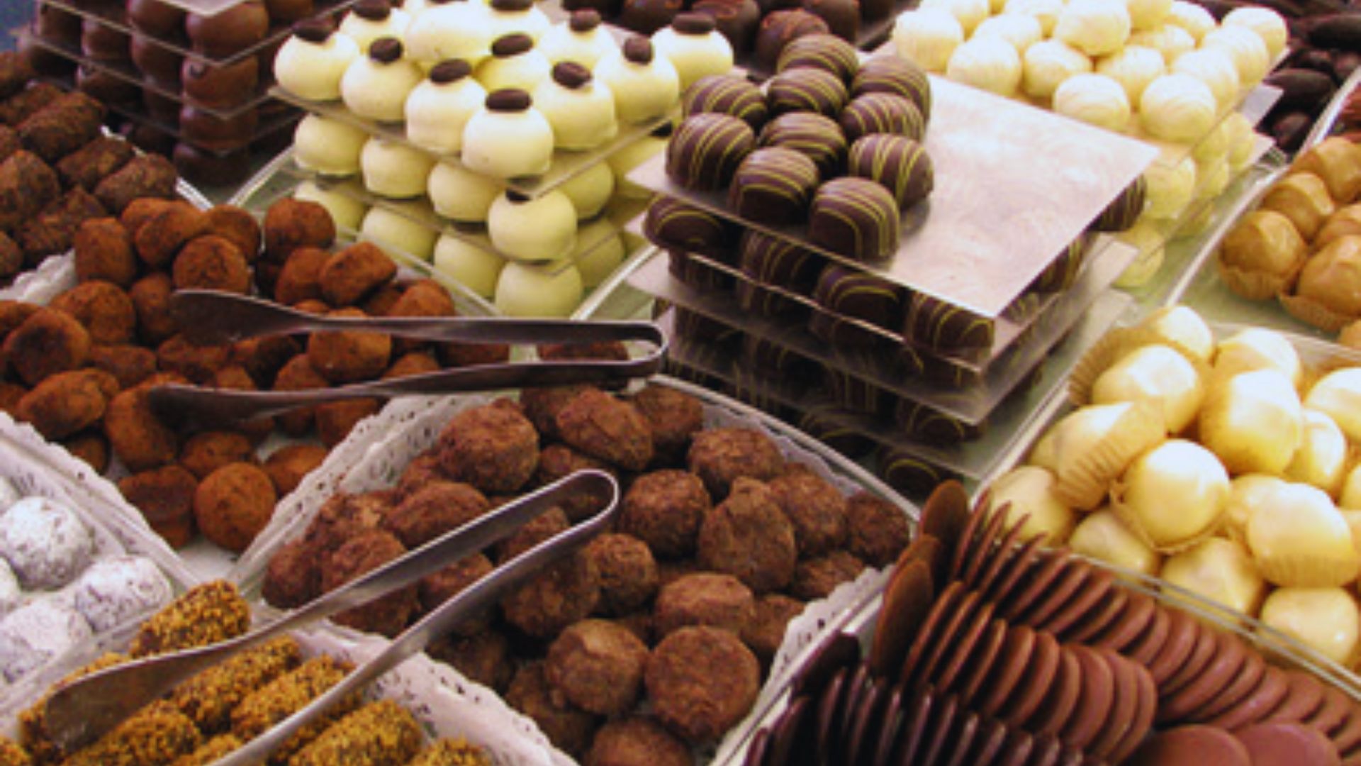 A variety of chocolates arranged in decorative baskets, showcasing different shapes and flavors.