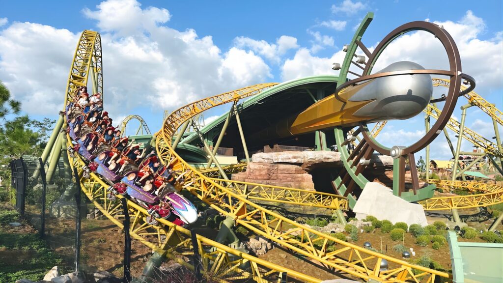 A roller coaster with excited riders enjoying the thrilling ride through twists and turns.