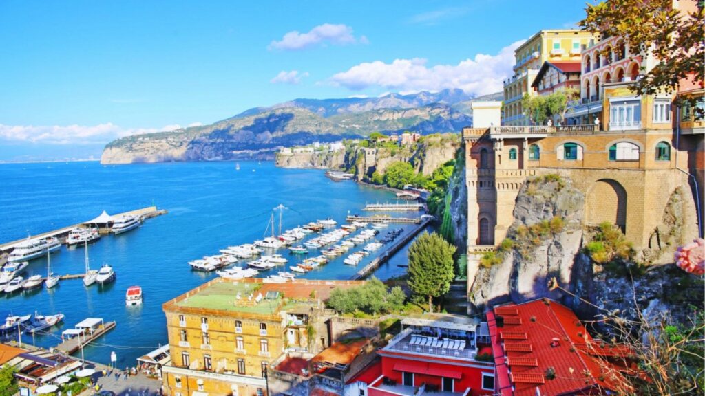 Scenic view of the Amalfi Coast in Italy, showcasing colorful cliffside villages and the sparkling Mediterranean Sea.